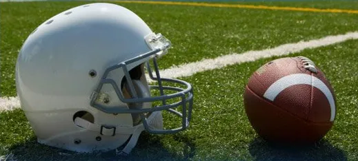 A football helmet and ball on the field