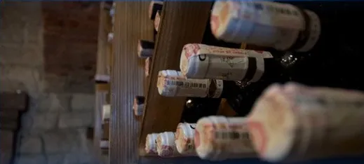 Wine bottles resting on a cellar rack